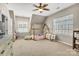 Charming bedroom with wooden bed frame, beanbag chair, and natural light from two windows at 11222 Huntington Meadow Ln, Charlotte, NC 28273
