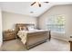 A cozy bedroom features a wood sleigh bed, neutral walls, and a large window offering natural light at 11222 Huntington Meadow Ln, Charlotte, NC 28273