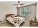 Cozy bedroom featuring a wood-framed bed, plush pillows and natural light creating a warm atmosphere at 11222 Huntington Meadow Ln, Charlotte, NC 28273