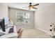 Bedroom featuring light walls, neutral carpet, a ceiling fan, a desk, and a pink chair at 11222 Huntington Meadow Ln, Charlotte, NC 28273