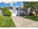 Charming two-story home with a well-manicured lawn and a long concrete driveway leading to an attached garage at 11222 Huntington Meadow Ln, Charlotte, NC 28273