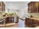 Well-lit kitchen featuring granite countertops, stainless steel appliances, and dark wood cabinetry in an open layout at 11222 Huntington Meadow Ln, Charlotte, NC 28273