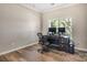 Office space featuring hardwood floors, light walls, crown molding, a dark desk, and two computer monitors at 11222 Huntington Meadow Ln, Charlotte, NC 28273