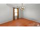 Bright bedroom featuring hardwood floors and a stylish chandelier at 11415 Serenity Way, Charlotte, NC 28269