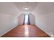 This room features hardwood flooring, and a window with blue curtains at 11415 Serenity Way, Charlotte, NC 28269