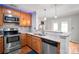 Updated kitchen boasts stainless steel appliances, granite countertops, and ample cabinet space at 11415 Serenity Way, Charlotte, NC 28269