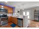 Well-lit kitchen with stainless steel appliances, granite countertops, and hardwood flooring at 11415 Serenity Way, Charlotte, NC 28269