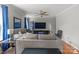 Spacious living room featuring hardwood floors, a ceiling fan, and blue accents at 11415 Serenity Way, Charlotte, NC 28269