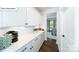 Convenient butler's pantry with white cabinets, sleek hardware, and a view into the dining room at 118 Fordingbridge Ln, Mooresville, NC 28115
