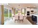Elegant dining room with a modern chandelier, large windows, and a view of the landscaped backyard at 118 Fordingbridge Ln, Mooresville, NC 28115
