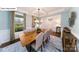 Bright dining room with coffered ceiling, large windows, and a stylish chandelier above a wooden table at 118 Fordingbridge Ln, Mooresville, NC 28115