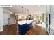Modern kitchen with a large island, stainless steel appliances, and an open view into the dining and living areas at 118 Fordingbridge Ln, Mooresville, NC 28115