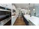 Modern kitchen features white cabinets, stainless steel appliances, and a large island with a farmhouse sink at 118 Fordingbridge Ln, Mooresville, NC 28115