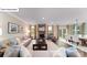 Spacious living room featuring a stone fireplace, neutral decor, and an adjacent dining area at 118 Fordingbridge Ln, Mooresville, NC 28115