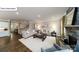 Bright living room featuring neutral decor, a stone fireplace, and hardwood flooring at 118 Fordingbridge Ln, Mooresville, NC 28115