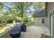 Back deck features a grill, storage shed, and a fenced in yard with mature trees at 119 Lakenheath Ln, Matthews, NC 28105