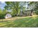 A spacious backyard featuring a shed and wire fence at 119 Lakenheath Ln, Matthews, NC 28105