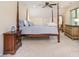 Spacious bedroom featuring a four-poster bed, ceiling fan, and neutral paint at 119 Lakenheath Ln, Matthews, NC 28105