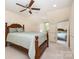Bedroom with a four-poster bed, ceiling fan, neutral paint, and large mirror at 119 Lakenheath Ln, Matthews, NC 28105