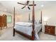 Bedroom with a four-poster bed, ceiling fan, and neutral paint at 119 Lakenheath Ln, Matthews, NC 28105