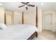 Bright bedroom featuring a four-poster bed, ceiling fan, and neutral paint at 119 Lakenheath Ln, Matthews, NC 28105