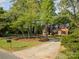 Charming brick home with mature trees and a circular driveway at 119 Lakenheath Ln, Matthews, NC 28105
