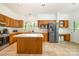 Spacious kitchen with an island, stainless steel appliances, and oak cabinetry at 119 Lakenheath Ln, Matthews, NC 28105