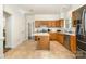 Classic kitchen with tile floors, oak cabinets, and a center island at 119 Lakenheath Ln, Matthews, NC 28105
