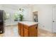 Open kitchen featuring a center island, tile floors, and stainless steel appliances at 119 Lakenheath Ln, Matthews, NC 28105