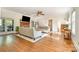 Bright living room featuring hardwood floors, a brick fireplace, and ample natural light at 119 Lakenheath Ln, Matthews, NC 28105