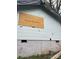 View of exterior with boarded up window and damage on siding at 119 Mitchell St, Salisbury, NC 28144