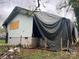 Exterior of property with damage and covered with black tarp at 119 Mitchell St, Salisbury, NC 28144