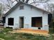 Exterior view of a home in need of renovation, featuring wood and missing windows at 119 Mitchell St, Salisbury, NC 28144