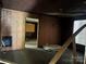 Unfinished living room view showing dark ceiling and floors, undergoing renovation at 119 Mitchell St, Salisbury, NC 28144