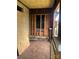 Unfinished porch with wooden boards and yellow ceiling, awaiting restoration at 119 Mitchell St, Salisbury, NC 28144