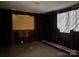 An unfinished room with exposed framework and tarp-covered windows, awaiting renovation at 119 Mitchell St, Salisbury, NC 28144