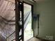 A room with tarp-covered walls and exposed electrical components, undergoing renovation at 119 Mitchell St, Salisbury, NC 28144