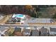 An aerial view showcases the community pool and clubhouse, surrounded by lush landscaping and ample parking at 121 Little Kennerly Dr, Mooresville, NC 28115