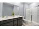 Bathroom featuring double sinks, quartz countertop, and a glass door shower at 121 Little Kennerly Dr, Mooresville, NC 28115