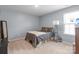 Neutral bedroom with natural light, simple decor, and carpeted floor at 121 Little Kennerly Dr, Mooresville, NC 28115