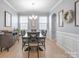 Elegant dining room featuring modern chandelier, wainscoting, and natural light at 121 Little Kennerly Dr, Mooresville, NC 28115