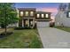 Charming brick two-story home featuring a manicured lawn and a spacious two-car garage at 121 Little Kennerly Dr, Mooresville, NC 28115