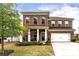 Charming brick two-story home with well-manicured lawn and a two-car garage on a sunny day at 121 Little Kennerly Dr, Mooresville, NC 28115