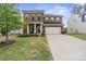 Charming brick two-story home featuring a manicured lawn and a spacious two-car garage at 121 Little Kennerly Dr, Mooresville, NC 28115