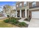 Inviting front porch with white columns, a cozy seating area, and lush landscaping at 121 Little Kennerly Dr, Mooresville, NC 28115