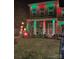 Charming home exterior adorned with festive red and green holiday lighting and whimsical decorations at 121 Little Kennerly Dr, Mooresville, NC 28115