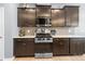 Kitchen features dark cabinets, stainless steel range and microwave, and neutral countertops at 121 Little Kennerly Dr, Mooresville, NC 28115