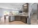 Kitchen island with dishwasher and sink faces the living area with a fireplace at 121 Little Kennerly Dr, Mooresville, NC 28115