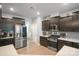 Modern kitchen features stainless steel appliances, dark cabinetry, and tile backsplash at 121 Little Kennerly Dr, Mooresville, NC 28115