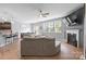 Bright living room boasts a fireplace, neutral color palette, and opens to the kitchen and dining areas at 121 Little Kennerly Dr, Mooresville, NC 28115